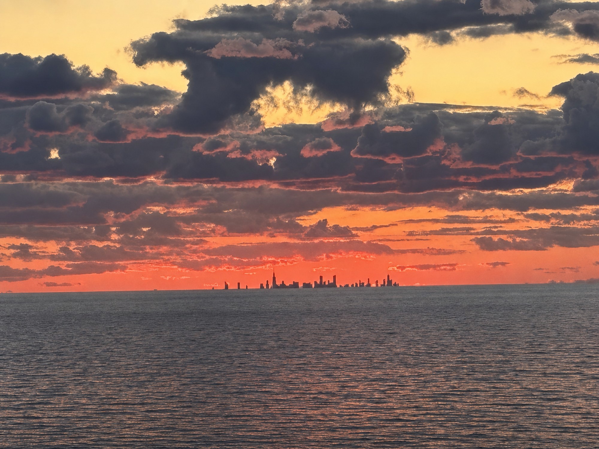 Sunset over Lake Michigan from Indiana Dunes Club, with the Chicago skyline silhouetted on the horizon